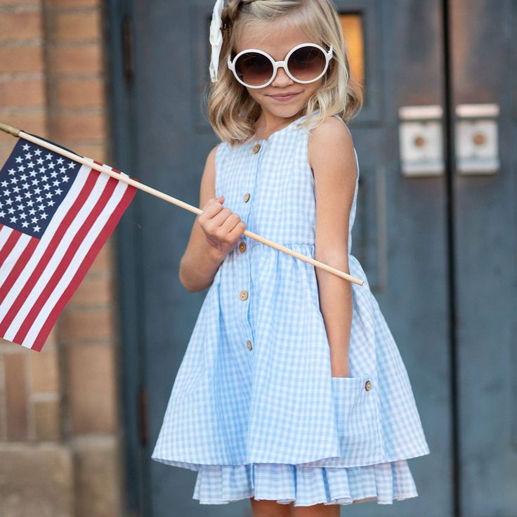 This dress is perfect for spring, Easter, and all those sunny summer days! It's got playful blue and white gingham checks, cute pockets, buttons, and even a fun ruffle under-layer. Totally adorable and oh-so-comfy for your little girl! Playful Spring Sundress For Day Out, Cute Ruffled Sundress For Picnic, Gingham Cotton Summer Dress, Gingham Plaid Dress With Ruffles For Day Out, Cute Gingham Plaid Dress For Summer, Casual Plaid Ruffle Dress For Spring, Cute Plaid Dress For Spring Picnic, Playful Summer Dresses With Pockets, Casual Gingham Sundress For Summer