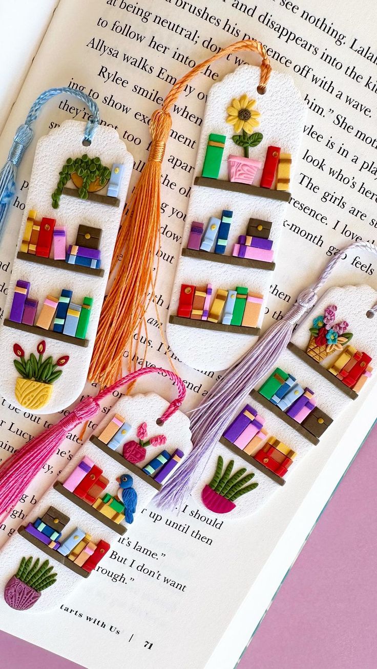 an open book with colorful books and tassels on it's pages,