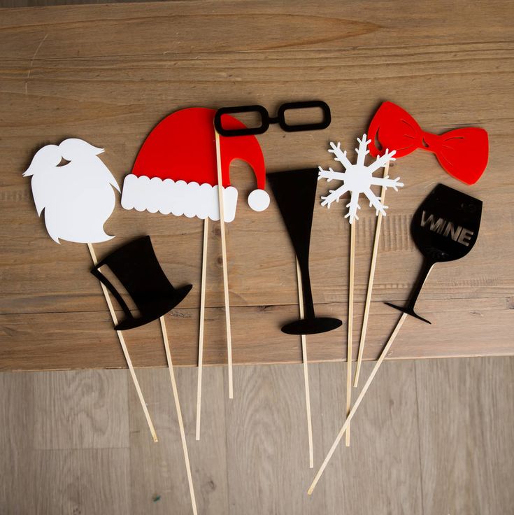 a group of santa hats and mustaches on sticks