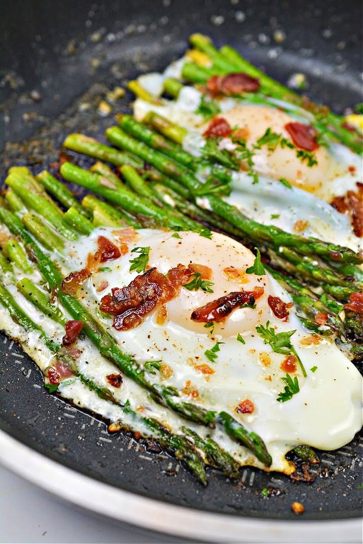 asparagus with eggs and bacon in a skillet