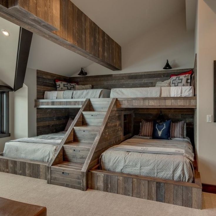 a bedroom with bunk beds and stairs in it