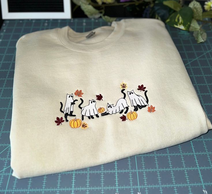 Embroidered Sweatshirt White Embroidered Logo T-shirt For Fall, White Embroidered Graphic T-shirt For Fall, White T-shirt With Embroidered Graphics For Fall, Embroidered White T-shirt For Fall, Casual Machine Embroidered Sweatshirt For Fall, Casual Fall Sweatshirt With Machine Embroidery, Custom Embroidered White T-shirt For Fall, White T-shirt With Custom Embroidery For Fall, White T-shirt With Embroidered Text For Fall