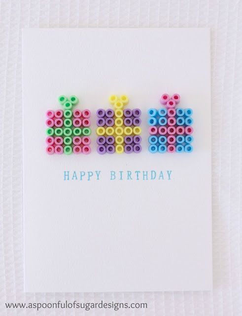 a happy birthday card with lego letters made out of colored plastic beads on a white background