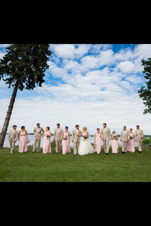 a large group of people standing on top of a lush green field