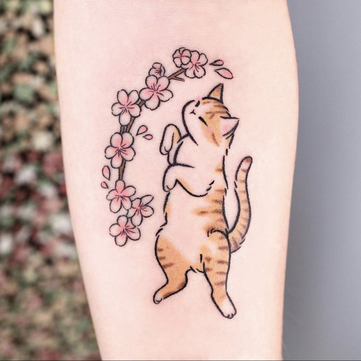 a cat is standing on its hind legs and reaching up for a flower tattoo design