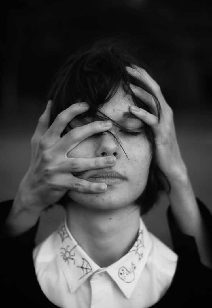 a woman covering her eyes with her hands