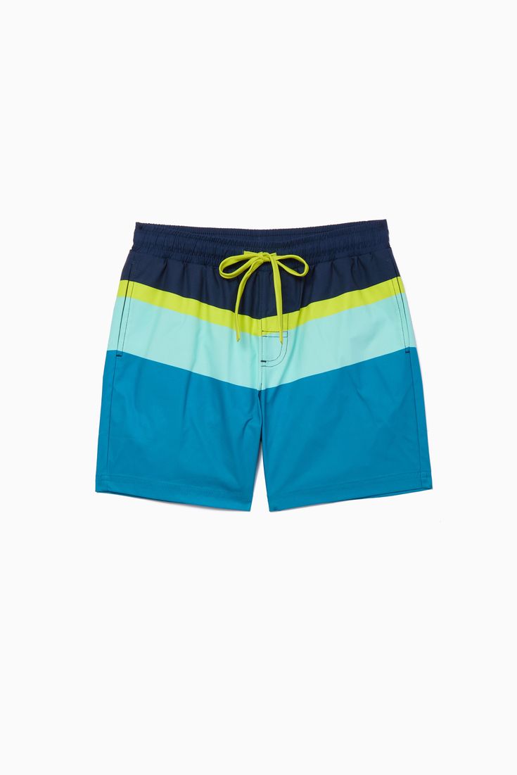 Hit the beach or head to the pool in our Playa Swim Trunk. Colorblocked panels and neon pops make it an epic match to our Surf's Up Rashguard! 🤿 Playful Blue Swim Trunks For Poolside, Playful Blue Swimwear For Water Sports, Playful Green Swim Trunks For Poolside, Playful Green Swim Trunks For Beach Season, Playful Green Swim Trunks For Beach, Fun Blue Swim Trunks For Beach Season, Playful Swimwear For Summer Water Sports, Neon Swimwear For Summer Poolside, Neon Summer Swimwear For Poolside