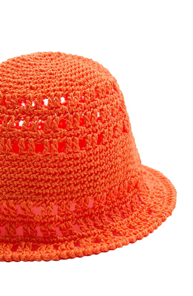 This crochet bucket hat is handcrafted from vibrant yarn to make a summery statement. Synthetic Imported Trendy Orange Summer Bucket Hat, Trendy Orange Bucket Hat For Summer, Trendy Hand Knitted Beach Hats, Trendy Crochet Sun Hat For Spring, Trendy Beach Hats Hand Knitted, Casual Orange Crochet Beach Hat, Casual Orange Crochet Hat For Beach, Orange Bucket Hat For Spring Vacation, Trendy Crochet Hat For Summer