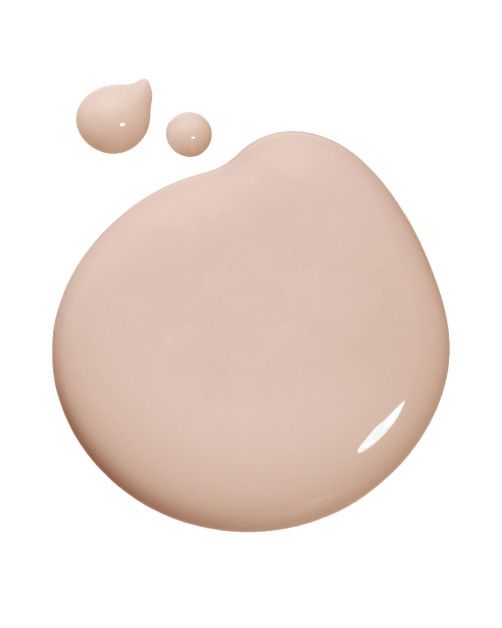 the base of a cream - colored liquid is shown with two drops of water on it