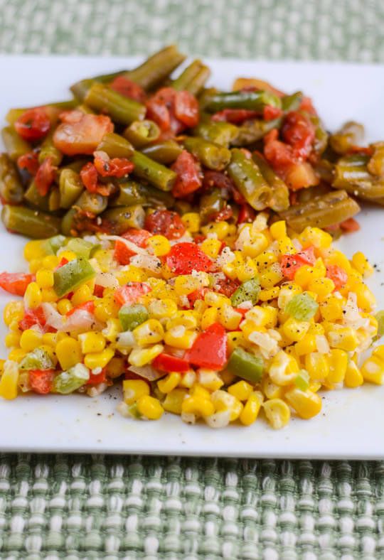 a white plate topped with corn and vegetables