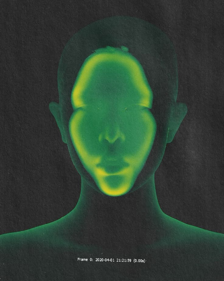 a man's face is glowing green in the dark