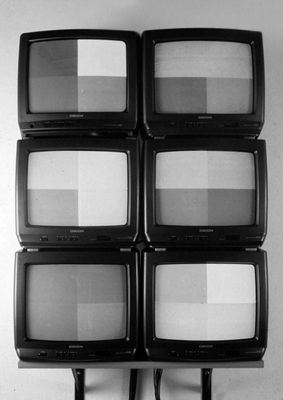 four televisions are stacked on top of each other