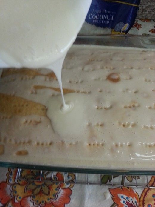 a person pouring milk into a baking pan