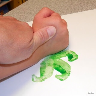 a person's hand on top of a piece of paper