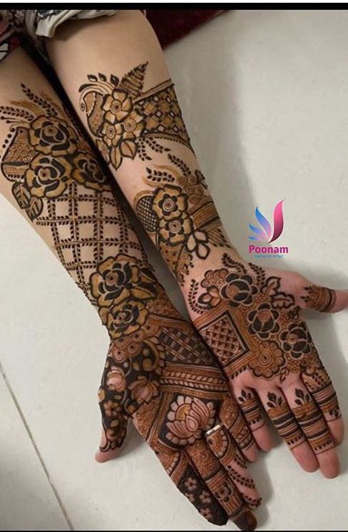 two hands with henna tattoos on them and one is showing the intricate design, while the