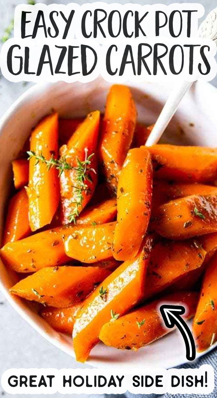 a white bowl filled with cooked carrots on top of a table