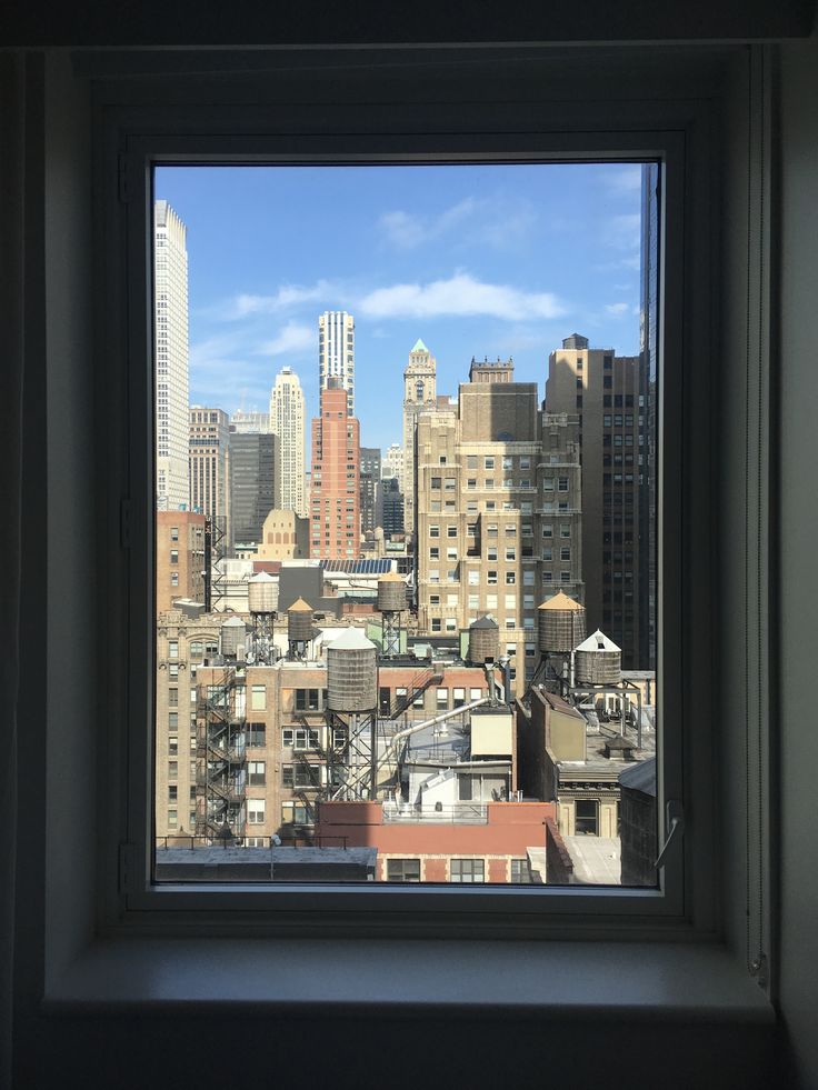 the view from an apartment window looking at buildings