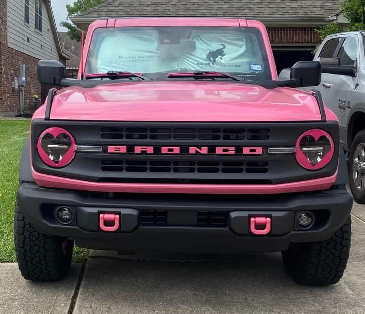 a pink truck parked in front of a house