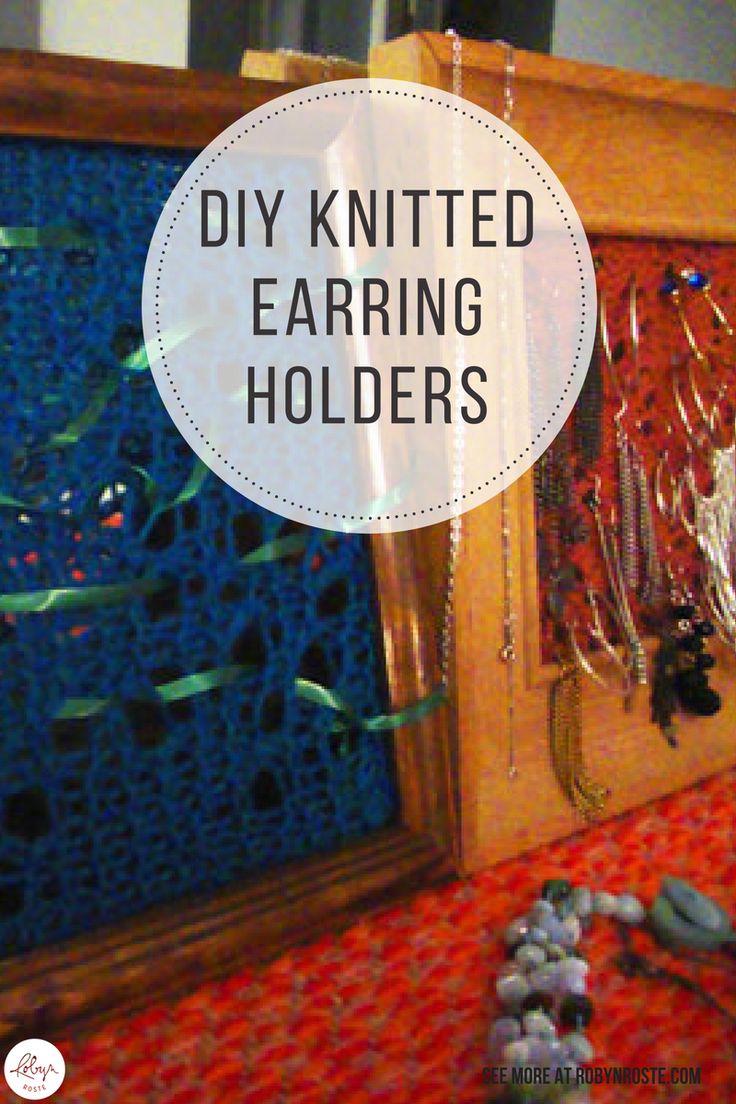 a wooden frame with beads and jewelry hanging on it, in front of a mirror that says diy knitted earring holders