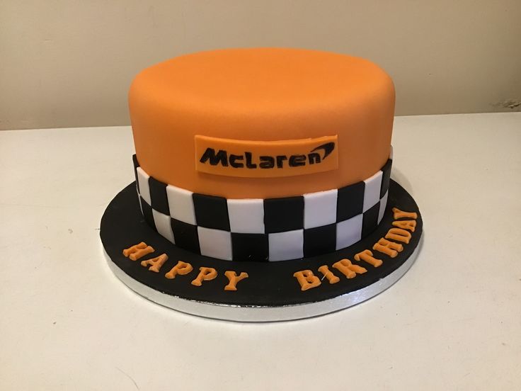 an orange and black birthday cake with the words happy birthday on it's side