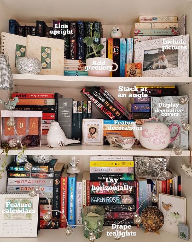 a book shelf filled with lots of books next to a vase and other items on top of it