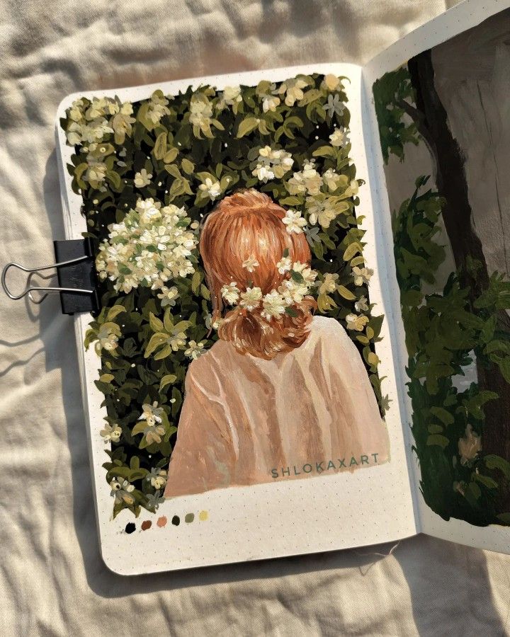 an open book with a painting of a girl and flowers