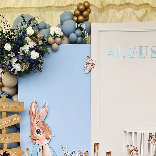 an image of a baby's room decorated with blue and gold decorations, such as flowers