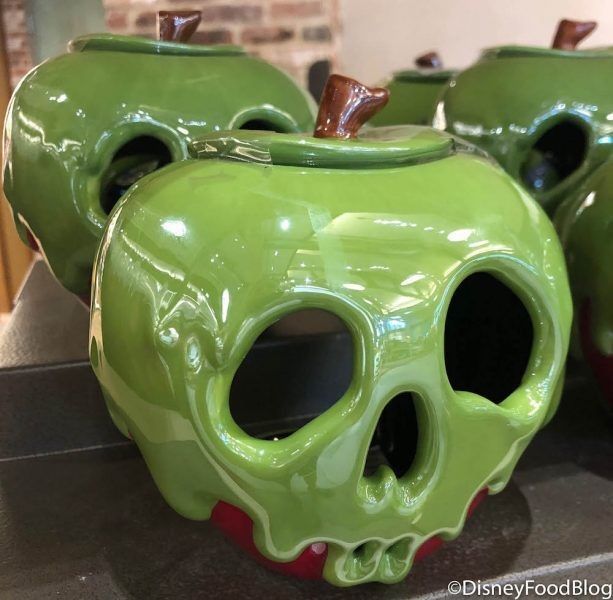 two green vases sitting on top of a counter