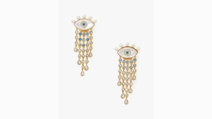 Our new statement-making earrings add a cool pop of sparkle to your summertime looks. This style features the Evil Eye a culturally treasured symbol of protection. | Kate Spade Evil Eye Statement Fringe Earrings, Cream Luxury Summer Party Jewelry, Kate Spade White Jewelry With Matching Earrings, Kate Spade White Jewelry Set With Matching Earrings, Silver Kate Spade Earrings Gift, Kate Spade Drop Earrings As Gift, Kate Spade Jewelry With Matching Earrings For Gift, Kate Spade Jewelry Gift Set With Earrings, Kate Spade Jewelry Gift Set With Matching Earrings, Kate Spade Dangle Earrings As A Gift