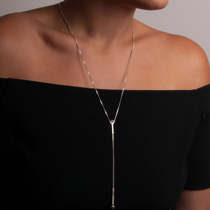 An architectural sliding lariat with 3mm stones at the top and bottom constructed with small and medium box chain. As an added feature, the necklace can be adjusted from 20 to 24 inches. - 5” long drop- High polish- Lobster clasp closureSequence Collection Modern Formal Necklaces With Long Drop, Formal Long Drop Chain Necklace, Modern Dangle Drop Necklace As Gift, Modern Sterling Silver Long Drop Necklace, Modern Long Drop Sterling Silver Necklace, Modern Dangle Drop Necklace For Gifts, Silver Lariat Necklace With Box Chain, Formal Box Chain Lariat Necklace, Formal Lariat Necklace With Box Chain