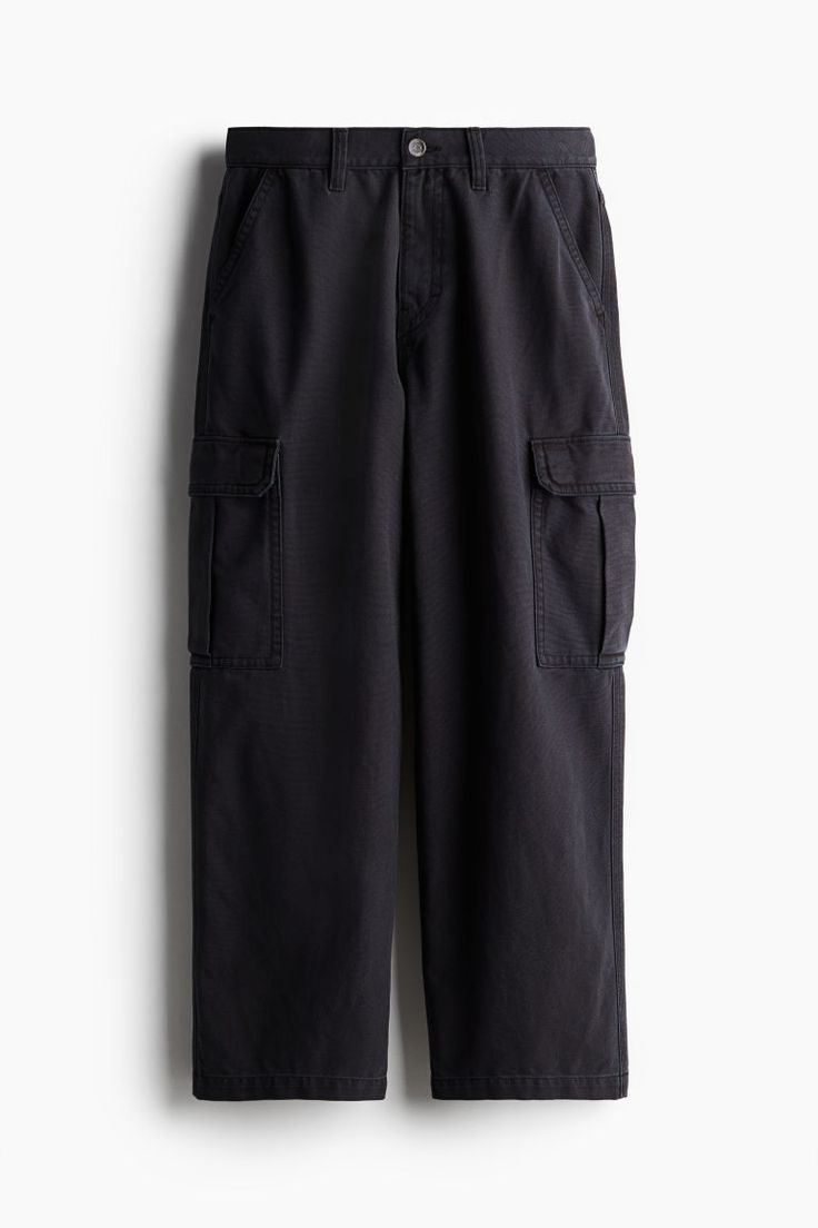 Baggy-fit cargo pants in thick cotton canvas with a casual  but not oversized silhouette. Zip fly with button  side pockets  back pockets  and bellows leg pockets with flap and snap fasteners. Wide-leg Work Pants With Cargo Pockets For Streetwear, Relaxed Fit Wide-leg Utility Cargo Pants, Casual Wide-leg Pants With Flap Pockets, Utility Wide-leg Cargo Pants With Hip Pockets, Urban Cotton Parachute Pants With Flap Pockets, Cotton Parachute Pants With Flap Pockets For Streetwear, Baggy Cargo Jeans For Work, Baggy Cotton Cargo Pants With Patch Pockets, Utility Wide-leg Cargo Pants