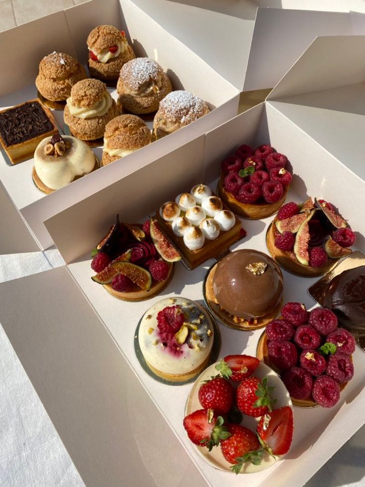 a box filled with lots of different types of pastries