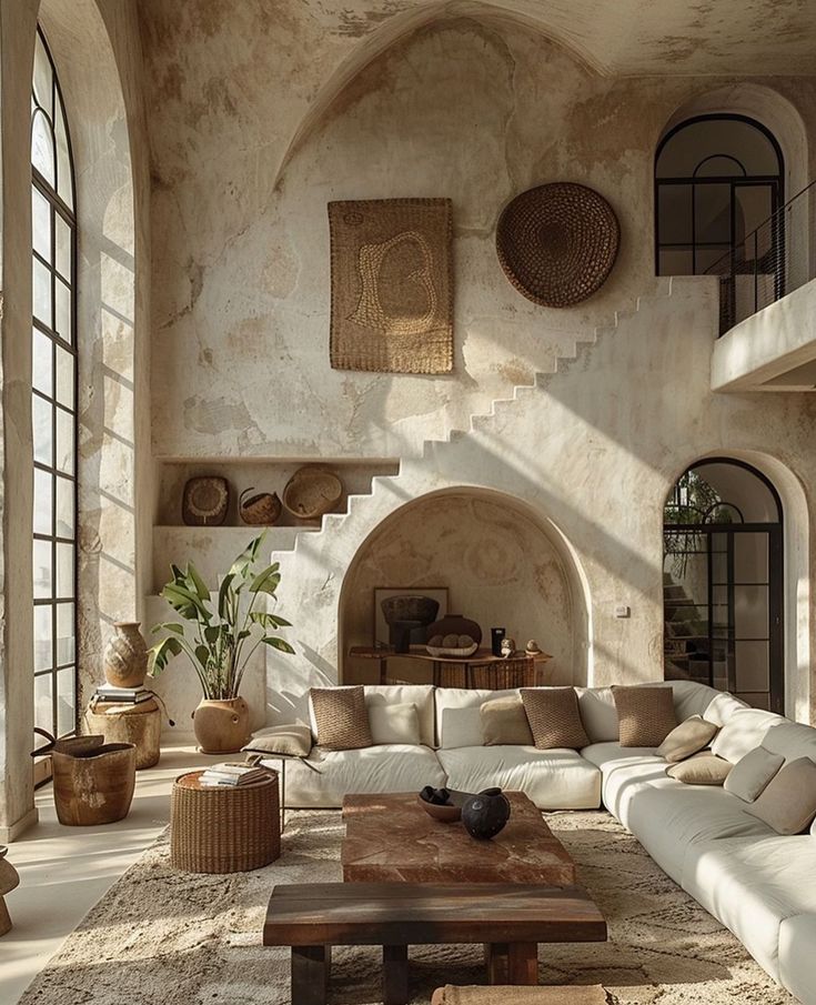 a living room filled with lots of furniture next to a fire place in a building