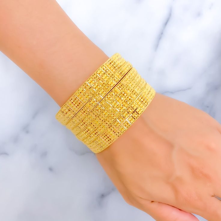 Indulge in luxury with our Royal Floral Checkered 22K Gold Bangle Set. Crafted in 22k gold, this exquisite set features a total weight of 92.5g, radiating opulence. The captivating floral checkered design and lustrous yellow gold finish make it a statement of high fashion. Bangle Size 2.7 with a 2.45" diameter opening. Set includes 6 stunning bangles PRODUCT DETAILS Gold Purity(karat): 22k Gold Weight(grams): 92.5 Item Finish: Yellow Gold Bangle Size: 2.7 Bangle Opening(diameter): 2.45" Number O 45 Number, 22k Gold Bangles, Gold Bangle Set, Checkered Design, Yellow Gold Bangle, Motif Design, Gold Bangle, Bangle Set, 22k Gold