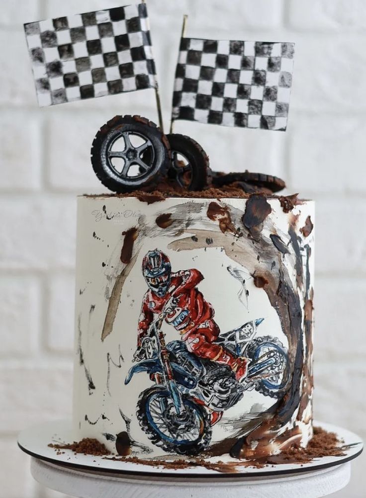 a cake decorated with a motorcycle and checkered flag