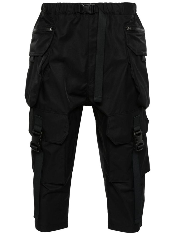 black cotton blend mid-rise elasticated waistband buckle fastening front zip fastening pockets two side cargo pockets rear zip fastening cropped Urban Style Tapered Leg Parachute Pants, Functional Black Pants With Belt Loops, Urban Tapered Leg Parachute Pants, Functional Black Parachute Pants With Belt Loops, Black Tapered Leg Cargo Pants With Functional Pockets, Black Tapered Leg Pants With Functional Pockets, Techwear Ankle-length Cargo Pants, Techwear Workwear Bottoms With Functional Pockets, Techwear Bottoms With Functional Pockets For Work