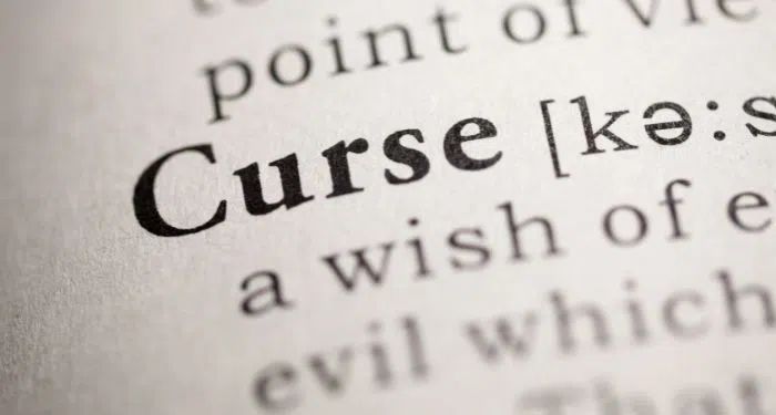 the word curse is highlighted in an open book