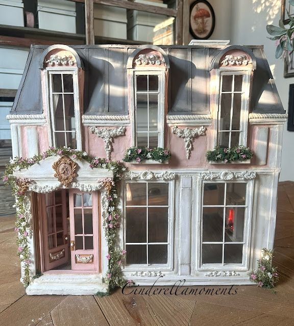 the doll house is decorated in pink and white