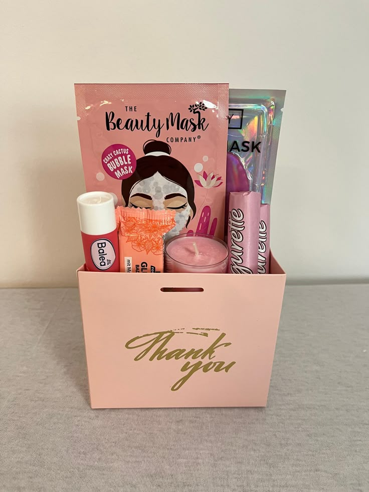 a pink box with beauty products inside it