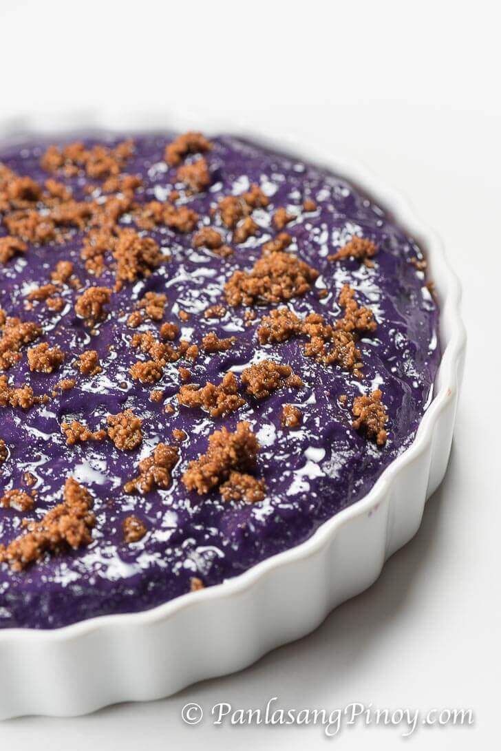 a purple dessert with crumbs on top