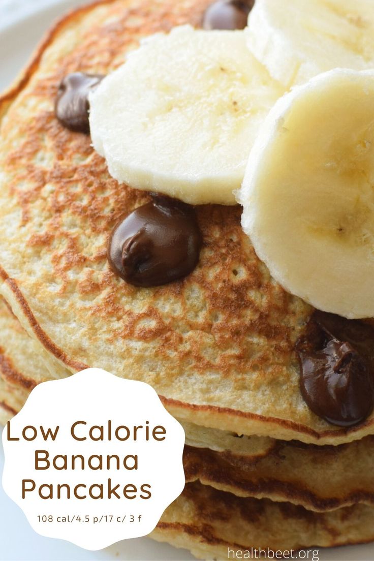 a stack of pancakes topped with bananas and chocolate chips