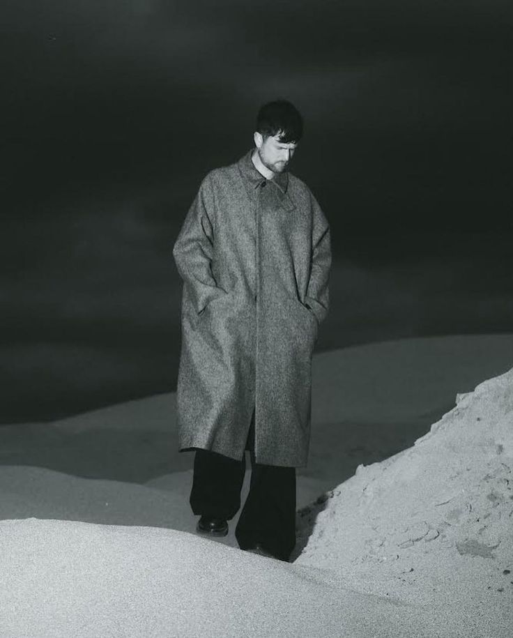 a man standing on top of a snow covered slope