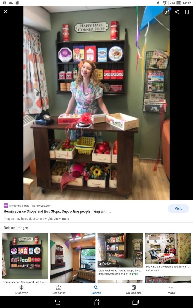 a woman standing in front of a table with boxes on it