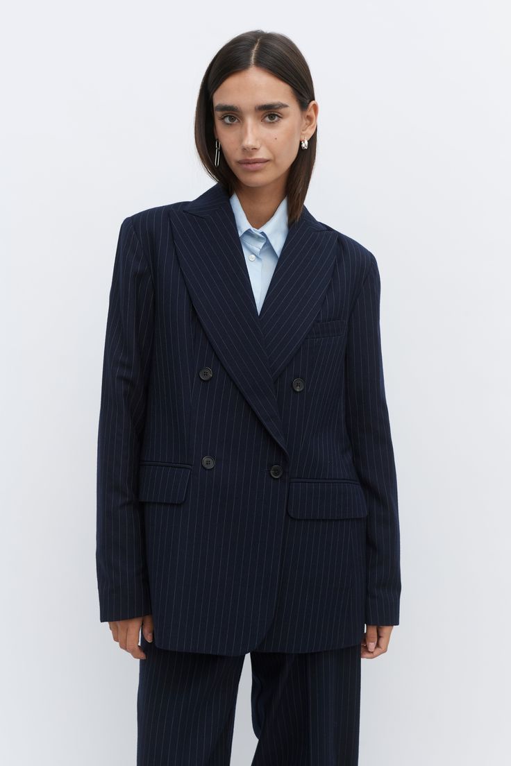 Our double breasted pinstripe tailored jacket is made of 100% wool, woven in Yorkshire. The jacket features horn buttons and two front pockets with flaps. The lining is sustainable made from FSC & Eco Vera viscose. The jacket can be worn as a full suit with the matching pinstripe wide leg trouser. Women Double Breasted Suit, Pin Stripe Suit Women, Pin Stripe Blazer Outfit, Pinstripe Suit Women, Striped Blazer Outfit, Formal Jackets For Women, Grey Pinstripe Suit, Tie Neck Shirt, Work Fits