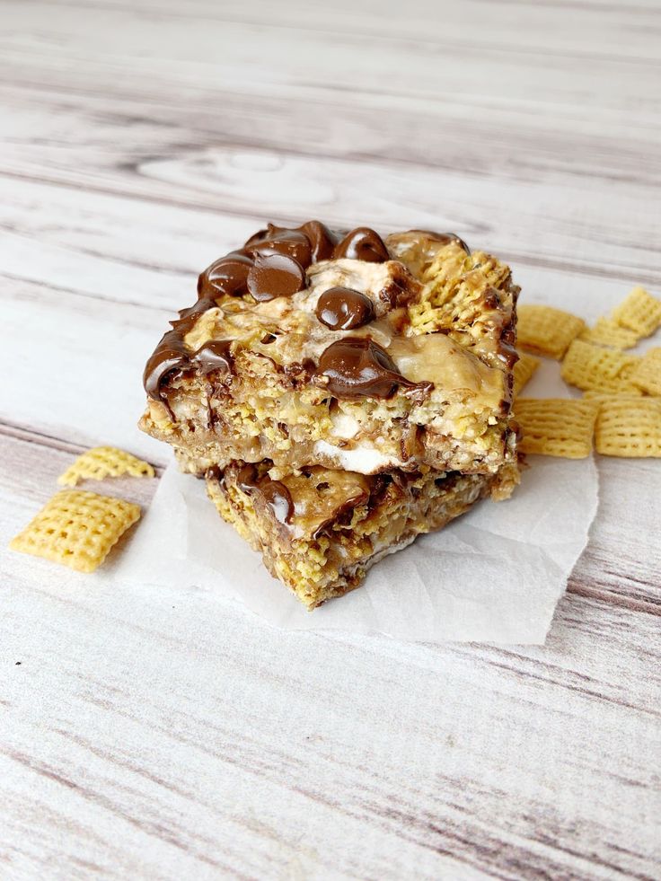 a close up of a piece of food on a table with crackers and chocolate chips