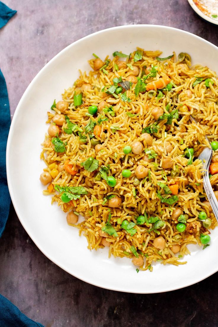 a white plate topped with rice and peas