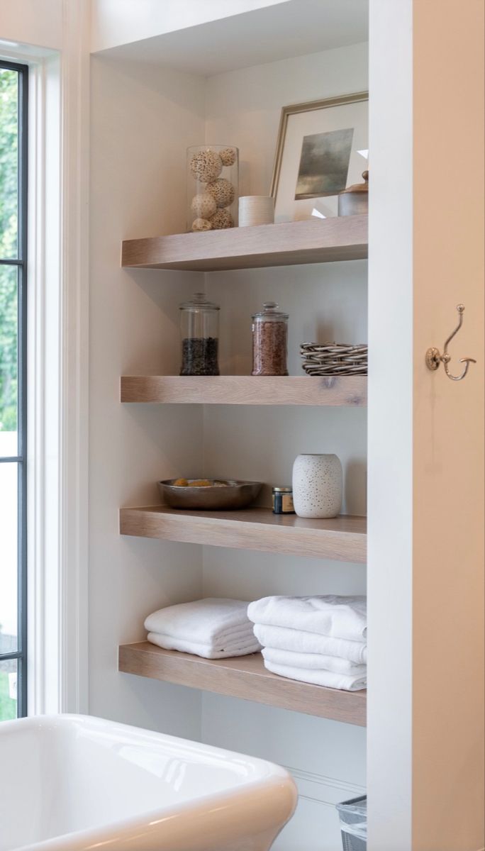 a bath room with a tub and shelves