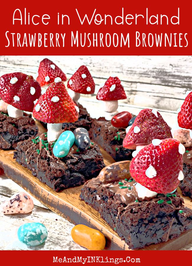 chocolate brownies with strawberries and marshmallows are on a wooden board