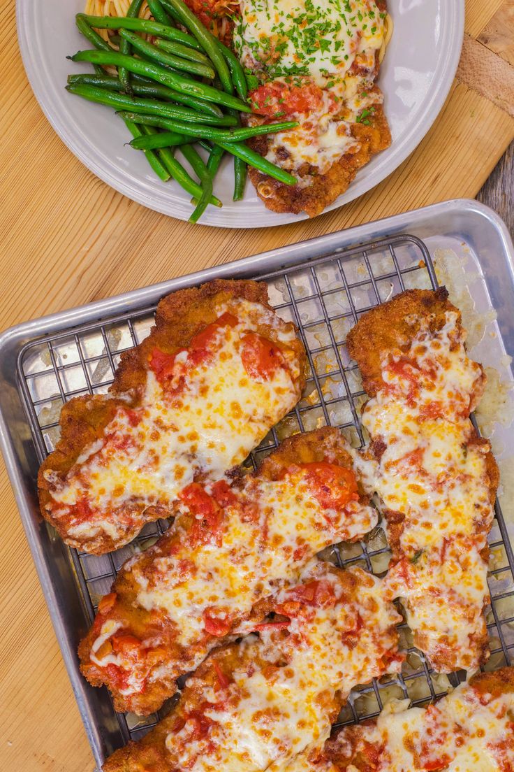 pizza and green beans on a table