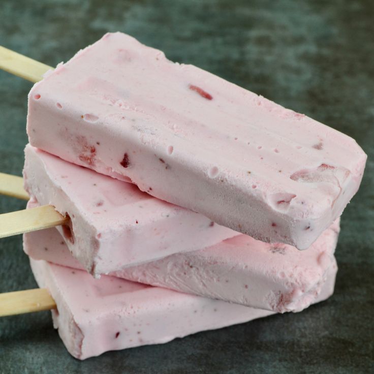 three popsicles stacked on top of each other with toothpicks sticking out of them